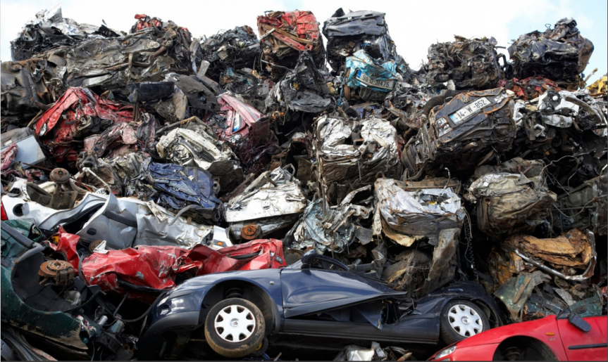 Piles of crushed cars at a metal recycling site in Belfast, Northern Ireland. Photograph- Alamy